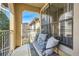 Cozy balcony with outdoor furniture, iron railings, and views of the surrounding buildings and trees at 3777 Peachtree Ne Rd # 1335, Atlanta, GA 30319
