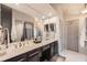 Bathroom featuring a double vanity with framed mirrors and a walk-in shower with curtain at 3777 Peachtree Ne Rd # 1335, Atlanta, GA 30319