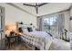 Cozy bedroom with neutral tones, a large window and a ceiling fan above a queen bed at 3777 Peachtree Ne Rd # 1335, Atlanta, GA 30319