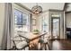 Bright dining area featuring a wood table set, modern light fixture and large window overlooking city buildings at 3777 Peachtree Ne Rd # 1335, Atlanta, GA 30319