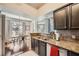 Charming kitchen featuring dark cabinetry, granite countertops, and a dining area at 3777 Peachtree Ne Rd # 1335, Atlanta, GA 30319