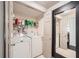 Functional laundry room with a washing machine, a dryer and plenty of storage space on shelves at 3777 Peachtree Ne Rd # 1335, Atlanta, GA 30319