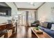 Bright living room with hardwood floors, a comfortable sofa, and balcony access at 3777 Peachtree Ne Rd # 1335, Atlanta, GA 30319