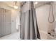 Shower area featuring a gray shower curtain, white tiling and a shower head with faucet at 3777 Peachtree Ne Rd # 1335, Atlanta, GA 30319