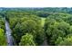 Aerial view of the tree-lined neighborhood with lush green space and winding roads at 3798 Kirkwood Nw Run, Kennesaw, GA 30144