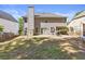 A spacious backyard featuring a well-maintained lawn and the rear exterior of the house, showcasing multiple windows at 3798 Kirkwood Nw Run, Kennesaw, GA 30144