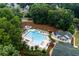 Aerial view of the community pool area, featuring a pool, clubhouse and lounge seating at 3798 Kirkwood Nw Run, Kennesaw, GA 30144