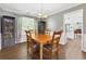 Charming dining room featuring natural wood table, wainscotting, and a view to the kitchen at 3798 Kirkwood Nw Run, Kennesaw, GA 30144