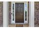 Close-up of the classic front door framed by stone accents and decorative sidelights, creating a warm entrance at 3798 Kirkwood Nw Run, Kennesaw, GA 30144