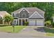 Charming two-story home featuring a stone accent facade, two-car garage, and a well-manicured lawn at 3798 Kirkwood Nw Run, Kennesaw, GA 30144