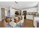 Modern kitchen boasts an island with seating, white cabinets, and sleek black appliances at 3798 Kirkwood Nw Run, Kennesaw, GA 30144