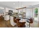 Bright kitchen features white cabinets, dark countertops, island with seating, and stainless steel appliances at 3798 Kirkwood Nw Run, Kennesaw, GA 30144