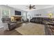 Cozy living room featuring a stone fireplace, large television, and comfortable seating arrangements at 3798 Kirkwood Nw Run, Kennesaw, GA 30144