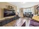 Spacious living area includes a large entertainment unit and view to adjacent room with abundant natural light at 3798 Kirkwood Nw Run, Kennesaw, GA 30144