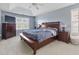 A Primary bedroom with a tray ceiling, neutral tones, and lots of natural light, creating a serene retreat at 3798 Kirkwood Nw Run, Kennesaw, GA 30144