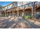 Spacious backyard featuring covered patios for townhomes, set against a backdrop of trees and sky at 4206 Townsend Ln, Atlanta, GA 30346