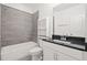 Well-lit bathroom with a shower and tub combination and a modern vanity with dark countertop at 4206 Townsend Ln, Atlanta, GA 30346