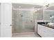 Beautiful bathroom with a walk-in shower featuring gray tile surround, granite countertops, and sleek fixtures at 4206 Townsend Ln, Atlanta, GA 30346