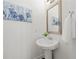 Bright powder room featuring a pedestal sink, a mirror, and elegant wall art at 4206 Townsend Ln, Atlanta, GA 30346