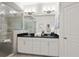 Elegant bathroom features a double vanity with black countertops and a spacious glass-enclosed shower at 4206 Townsend Ln, Atlanta, GA 30346