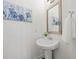 Stylish half bath with pedestal sink, modern fixtures, and decorative artwork at 4206 Townsend Ln, Atlanta, GA 30346