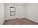 Neutral bedroom showing carpet floors and a window view of a brick building at 4206 Townsend Ln, Atlanta, GA 30346