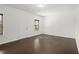 Spacious bedroom with hardwood floors, two windows, and a door with white trim at 4206 Townsend Ln, Atlanta, GA 30346