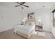 Cozy bedroom with neutral tones, a ceiling fan, and a plush upholstered bed illuminated by bedside lamps at 4206 Townsend Ln, Atlanta, GA 30346