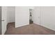 Spacious bedroom featuring neutral carpeting and a doorway leading to an ensuite bathroom with an open closet at 4206 Townsend Ln, Atlanta, GA 30346