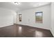 Bright bedroom featuring hardwood floors, two windows, and white trim throughout at 4206 Townsend Ln, Atlanta, GA 30346