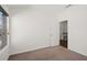 Bedroom with neutral carpet, window view and door to hallway and staircase at 4206 Townsend Ln, Atlanta, GA 30346