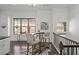 Bright breakfast nook area featuring a cozy table setting, adjacent to a kitchen with dark wood floors and neutral walls at 4206 Townsend Ln, Atlanta, GA 30346