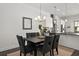 Elegant dining area featuring a table set for six, complemented by hardwood floors and stylish lighting at 4206 Townsend Ln, Atlanta, GA 30346