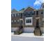 Attractive brick townhome featuring a two-car garage, inviting front steps, and classic architectural details at 4206 Townsend Ln, Atlanta, GA 30346