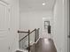 Upstairs hallway with dark hardwood floors, staircase, and natural light at 4206 Townsend Ln, Atlanta, GA 30346