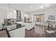 Modern, bright kitchen with stainless steel appliances, black countertops, a large island, and an adjacent breakfast nook area at 4206 Townsend Ln, Atlanta, GA 30346