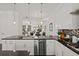 Well-equipped kitchen featuring stainless steel appliances, sleek black countertops, and a view into the living and dining areas at 4206 Townsend Ln, Atlanta, GA 30346