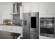 Modern kitchen featuring stainless steel appliances, sleek black countertops, and stylish backsplash at 4206 Townsend Ln, Atlanta, GA 30346