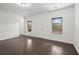 Large living room featuring hardwood floors, two windows, and white trim at 4206 Townsend Ln, Atlanta, GA 30346