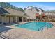 Pool area with a clear blue swimming pool, brick pavers, and surrounding buildings at 4206 Townsend Ln, Atlanta, GA 30346