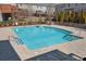 Inviting community pool with clear blue water, set in a brick-paved area, promising a refreshing retreat at 4206 Townsend Ln, Atlanta, GA 30346