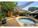 Inviting backyard featuring a hot tub, patio seating, and lush greenery, ideal for relaxation at 1545 Montreat Sw Pl, Atlanta, GA 30311