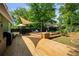 Multi-tiered wood deck backyard featuring a grill, outdoor seating, shade, and hot tub at 1545 Montreat Sw Pl, Atlanta, GA 30311