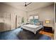 Comfortable bedroom features a ceiling fan, large mirror, and hardwood flooring at 1545 Montreat Sw Pl, Atlanta, GA 30311