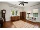 Spacious bedroom with hardwood floors, a ceiling fan and multiple windows for plenty of natural light at 1545 Montreat Sw Pl, Atlanta, GA 30311
