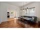 Open concept dining room with modern lighting, bench seating and access to the kitchen at 1545 Montreat Sw Pl, Atlanta, GA 30311