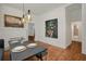 Dining room with decorative lighting, hardwood floors and large art piece at 1545 Montreat Sw Pl, Atlanta, GA 30311