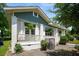 Inviting craftsman-style home with a covered porch, white brick pillars, and hanging ferns for added charm at 1545 Montreat Sw Pl, Atlanta, GA 30311