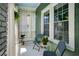 Cozy porch features stylish seating, sheer curtains, and a peaceful ambiance for enjoying the outdoors at 1545 Montreat Sw Pl, Atlanta, GA 30311