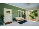 Serene front porch with cozy furniture, a ceiling fan, and a view of the lush front yard and neighborhood at 1545 Montreat Sw Pl, Atlanta, GA 30311